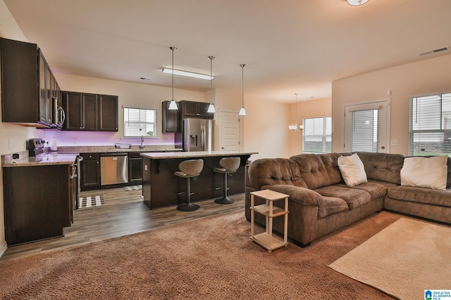 living area with dark wood-style flooring and visible vents
