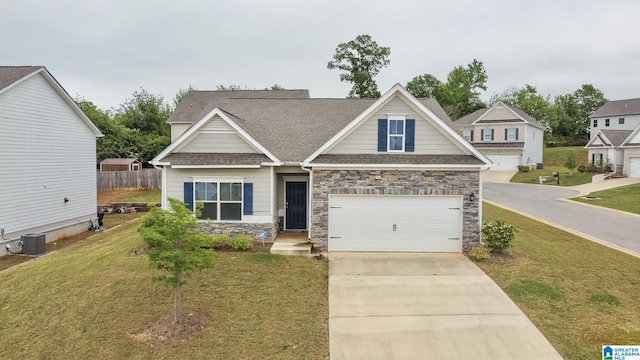 craftsman inspired home featuring driveway, fence, a front yard, and stone siding