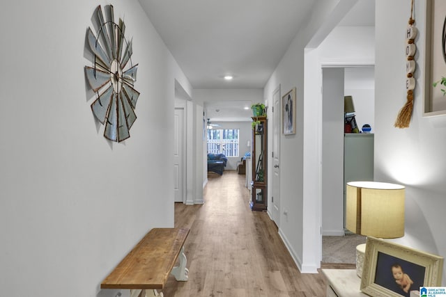 corridor with recessed lighting, baseboards, and light wood-type flooring