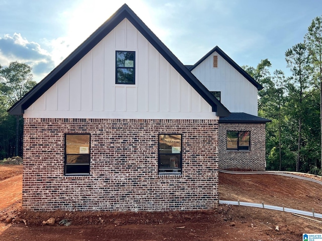 190 Estates Club Dr, Pell City, AL 35128 - view of side of property featuring board and batten siding and brick siding