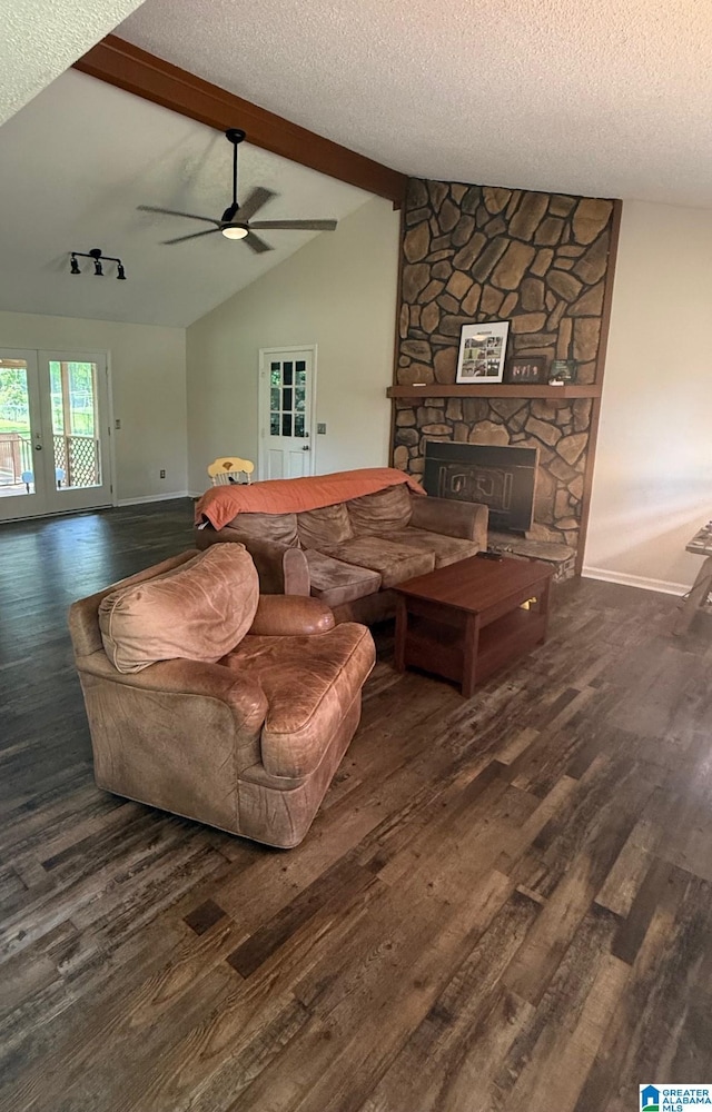 living area with a fireplace, a textured ceiling, and wood finished floors