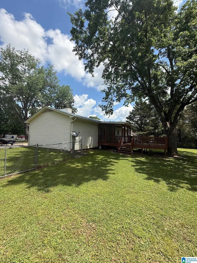 view of yard featuring fence and a deck