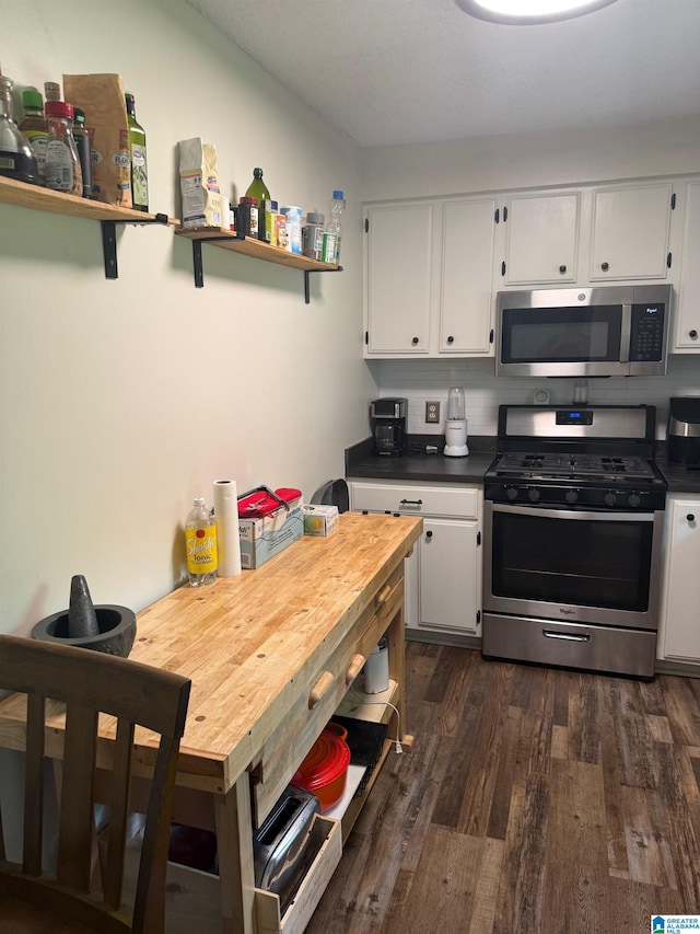 kitchen featuring appliances with stainless steel finishes, white cabinets, and dark wood finished floors
