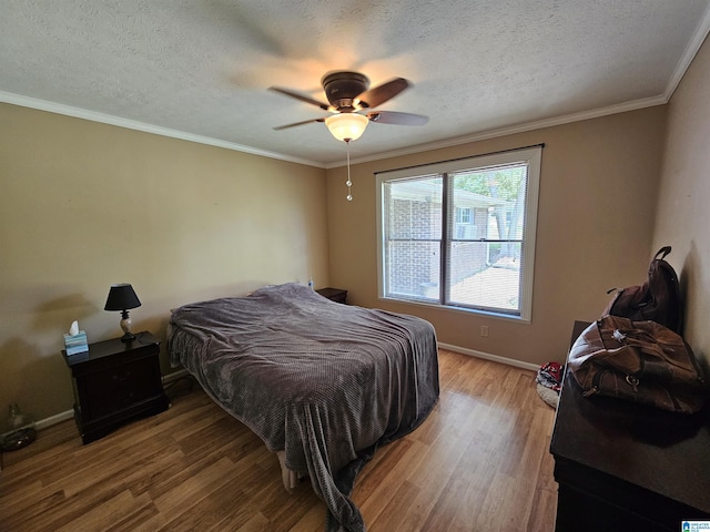 576 Chandler Mountain Rd, Steele, AL 35987 - bedroom featuring ceiling fan, crown molding, baseboards, a textured ceiling, and wood finished floors