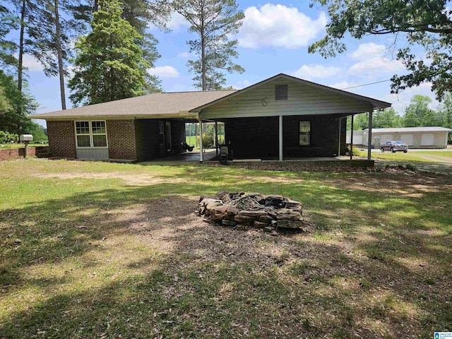 576 Chandler Mountain Rd, Steele, AL 35987 - view of front of house featuring a sunroom, a front yard, a fire pit, and brick siding