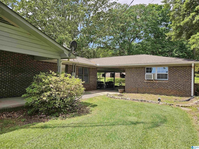 576 Chandler Mountain Rd, Steele, AL 35987 - exterior space featuring a front lawn, brick siding, and a carport