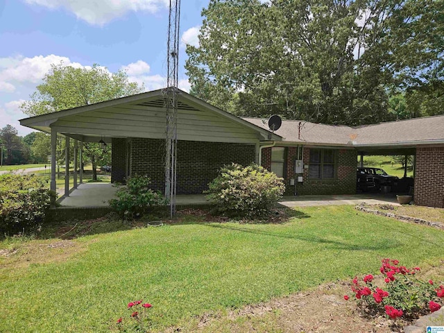 576 Chandler Mountain Rd, Steele, AL 35987 - exterior space featuring a front yard, an attached carport, and brick siding