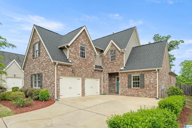 view of front of home with brick siding, driveway, roof with shingles, and a garage