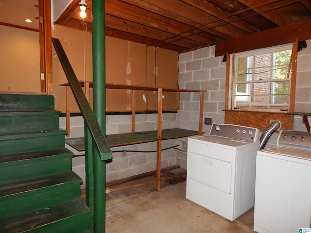laundry area featuring concrete block wall, laundry area, and independent washer and dryer