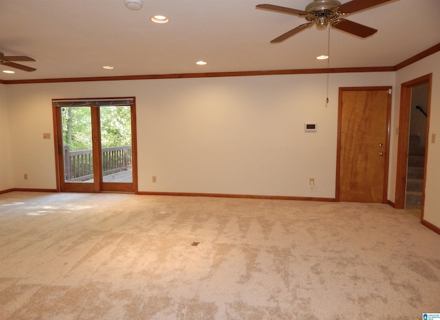 unfurnished room featuring crown molding, baseboards, light carpet, and a ceiling fan