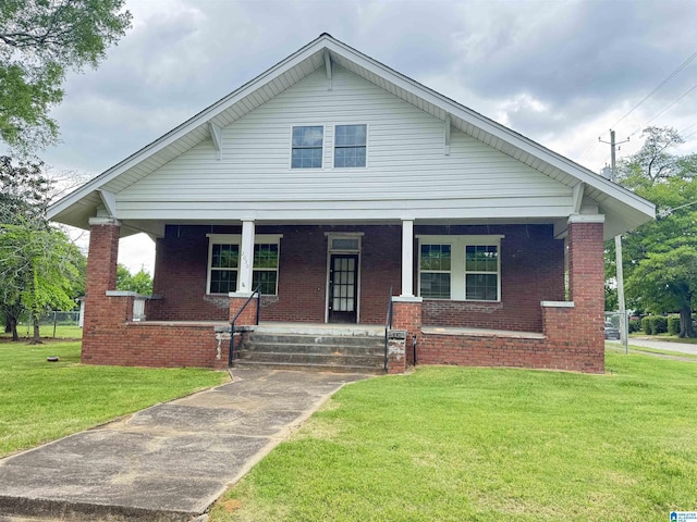 2030 Leighton Ave, Anniston, AL 36207 - bungalow-style home featuring brick siding, a porch, and a front yard