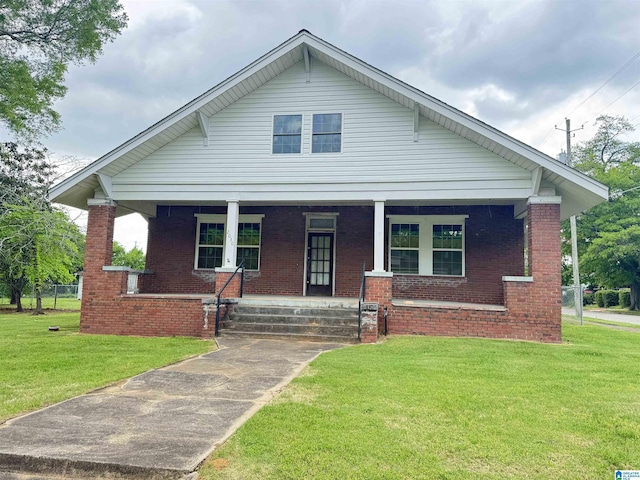 2030 Leighton Ave, Anniston, AL 36207 - bungalow-style home with a front yard, covered porch, and brick siding