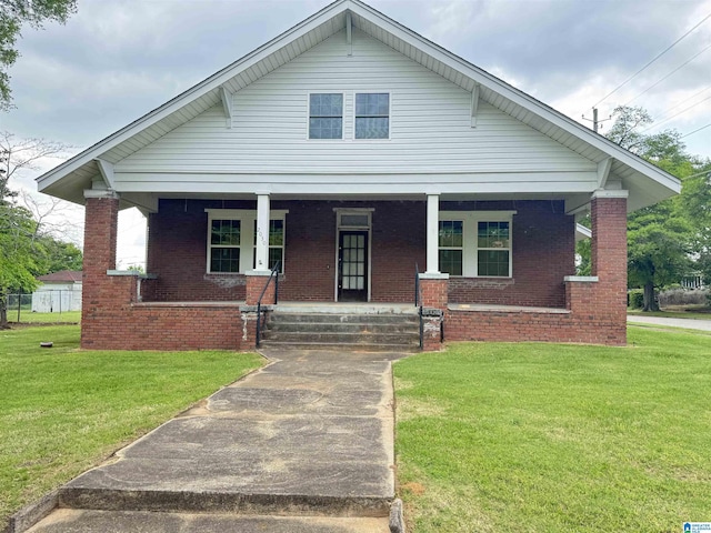 2030 Leighton Ave, Anniston, AL 36207 - bungalow-style home featuring a porch, a front yard, and brick siding