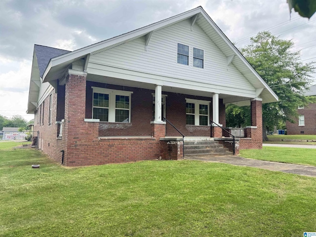 2030 Leighton Ave, Anniston, AL 36207 - bungalow-style house with a porch, a front lawn, and brick siding