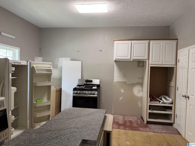 2030 Leighton Ave, Anniston, AL 36207 - kitchen with stainless steel gas range oven and white cabinetry