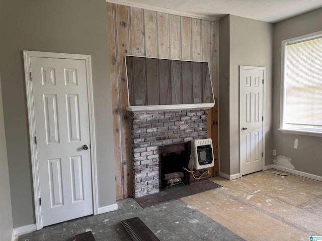 2030 Leighton Ave, Anniston, AL 36207 - unfurnished living room featuring heating unit, a wood stove, and baseboards