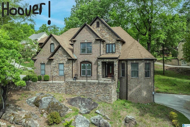 1200 Grand Oaks Cv, Hoover, AL 35244 - view of front facade with stone siding, a shingled roof, and brick siding