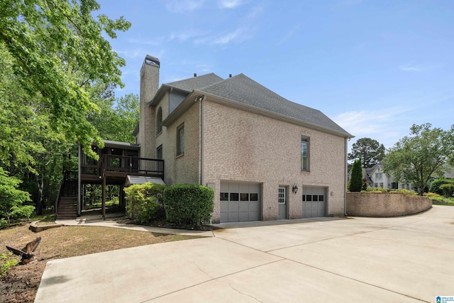 2004 Shandwick Ter, Birmingham, AL 35242 - view of side of property with driveway, a chimney, brick siding, an attached garage, and stairs