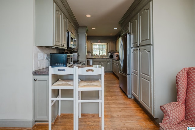 1426 Overlook Rd, Homewood, AL 35209 - kitchen featuring tasteful backsplash, light wood-style flooring, a sink, appliances with stainless steel finishes, and recessed lighting