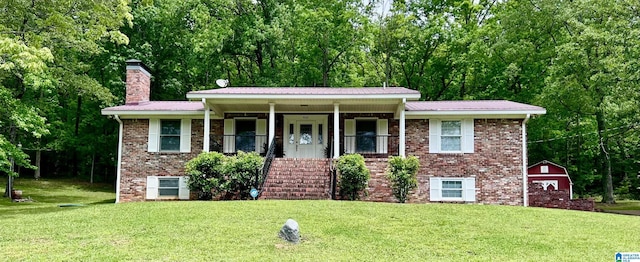 view of front of property with brick siding, a chimney, and a front lawn