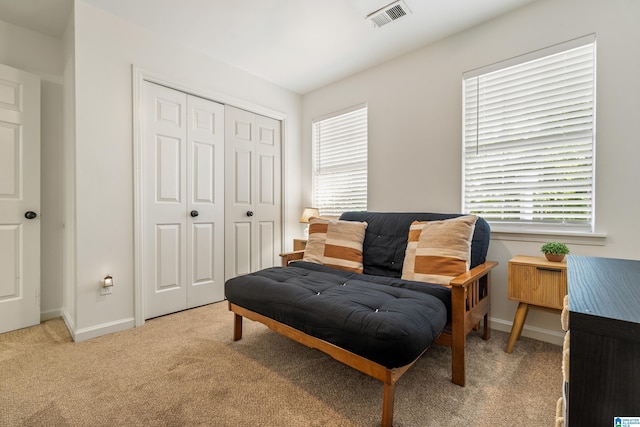 living area featuring visible vents, carpet, and baseboards