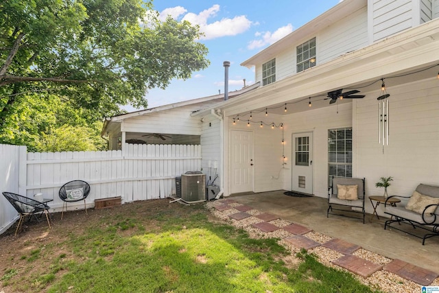 view of yard featuring central air condition unit, a patio, ceiling fan, and fence