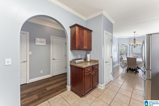 209 Vineyard Ln, Birmingham, AL 35242 - kitchen with baseboards, freestanding refrigerator, crown molding, and light tile patterned floors