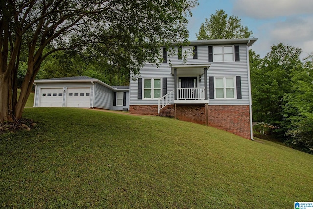 colonial-style house featuring brick siding, an attached garage, and a front yard