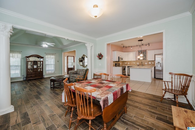dining room featuring a ceiling fan, wood finish floors, and decorative columns