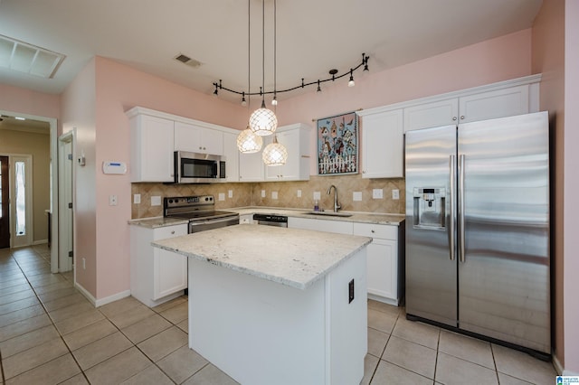 kitchen with visible vents, a sink, light tile patterned floors, and stainless steel appliances
