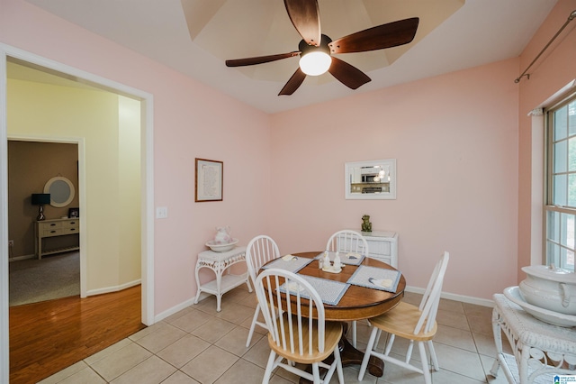 dining room featuring light tile patterned floors, ceiling fan, and baseboards