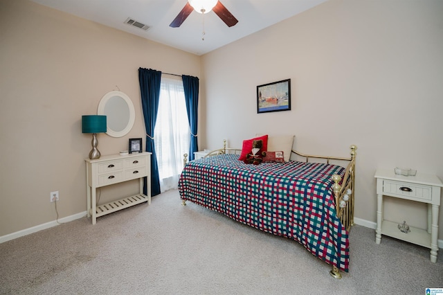 carpeted bedroom with visible vents, baseboards, and ceiling fan