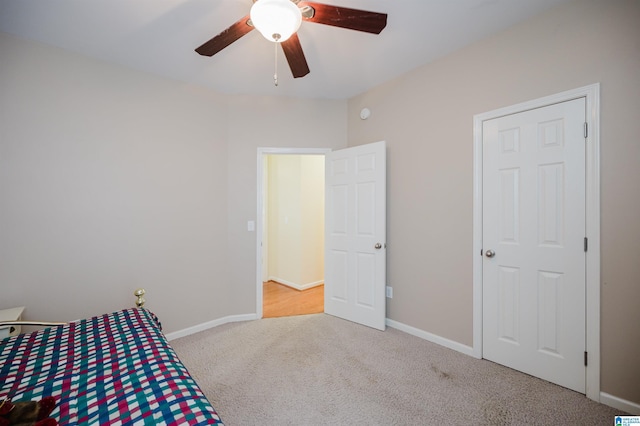 unfurnished bedroom featuring baseboards, carpet flooring, and a ceiling fan