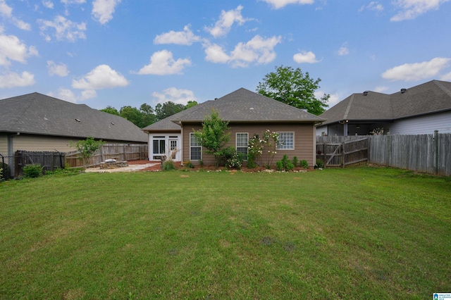 back of property featuring a lawn, a patio, and a fenced backyard
