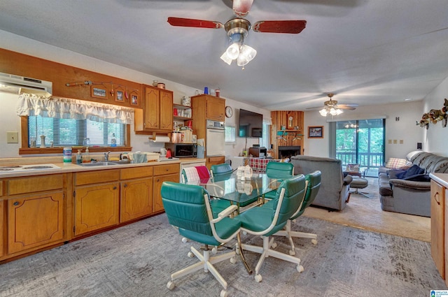 156 Wallace Dr, Shelby, AL 35143 - dining area with ceiling fan, plenty of natural light, light colored carpet, and a fireplace