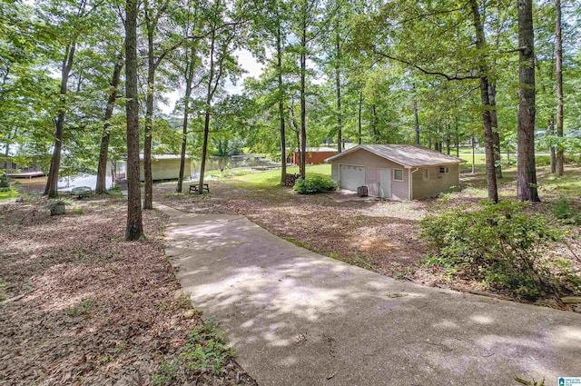 156 Wallace Dr, Shelby, AL 35143 - view of yard featuring an outbuilding, a garage, and view of wooded area