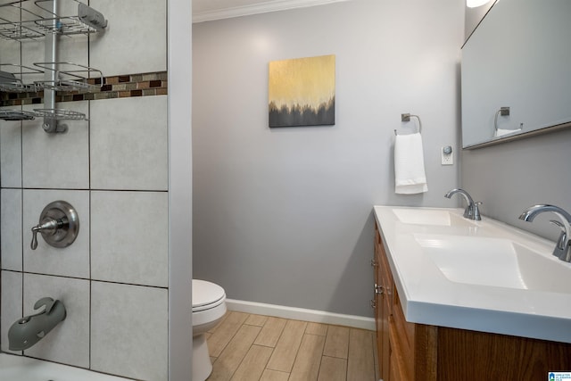full bathroom featuring double vanity, toilet, a sink, and wood tiled floor