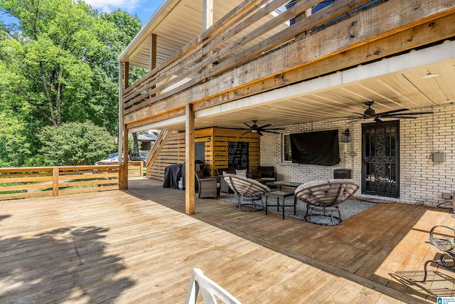 wooden terrace with an outdoor hangout area and ceiling fan
