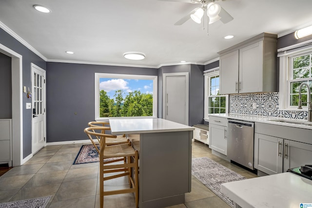 kitchen with a sink, dishwasher, and light countertops