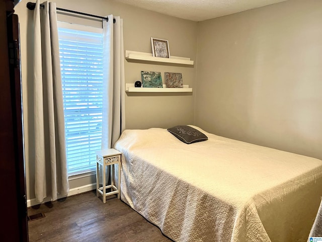 bedroom featuring dark wood-style flooring