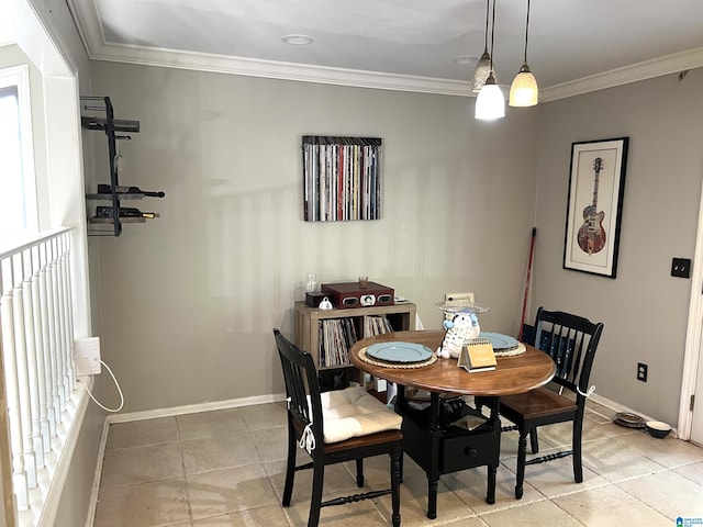 dining area with baseboards, ornamental molding, and light tile patterned floors