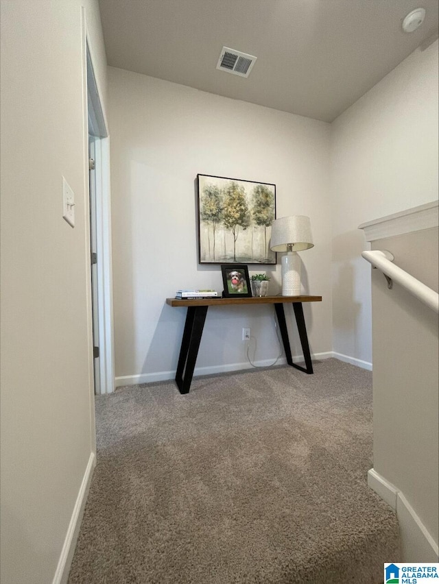 unfurnished office featuring carpet floors, baseboards, and visible vents