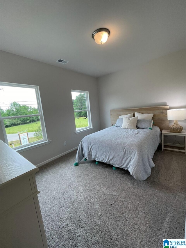 bedroom featuring carpet floors, baseboards, and visible vents