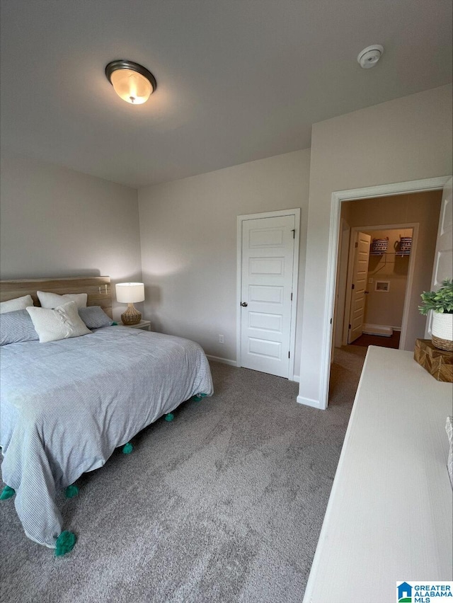 bedroom with baseboards and carpet flooring