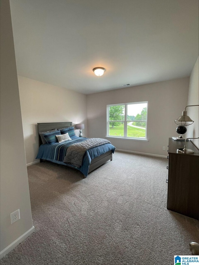 carpeted bedroom with baseboards and visible vents