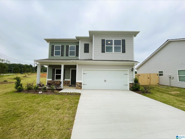 traditional-style home featuring stone siding, a garage, a front yard, covered porch, and driveway