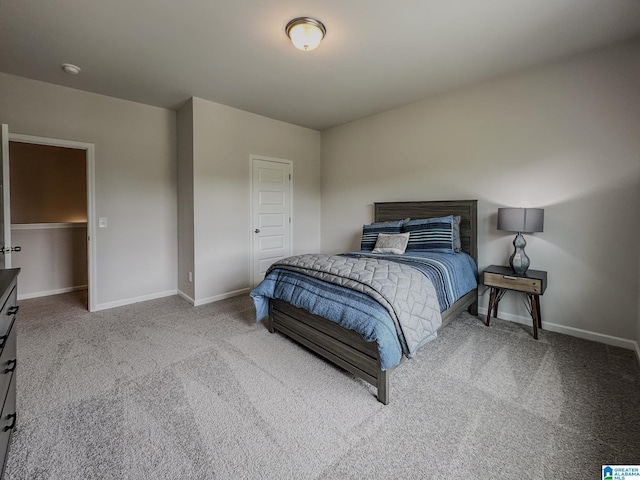 bedroom with baseboards and carpet