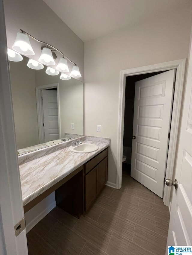 bathroom with toilet and vanity