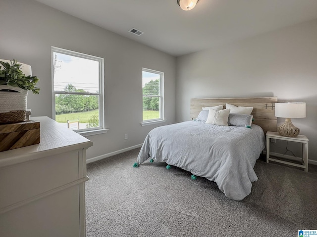 carpeted bedroom with visible vents and baseboards