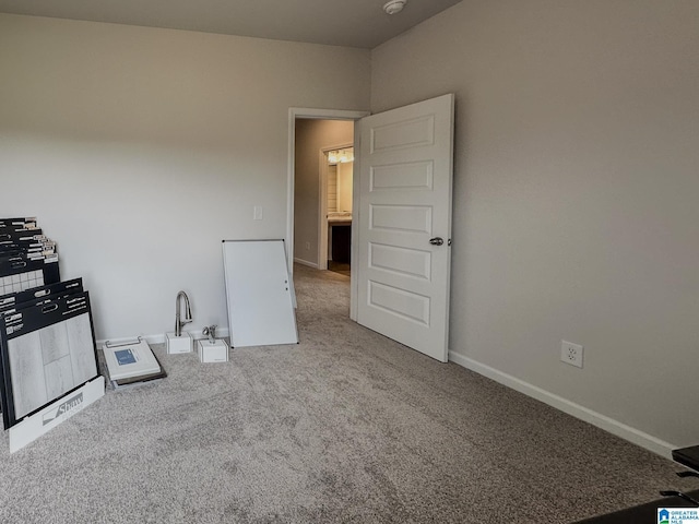 carpeted spare room with baseboards